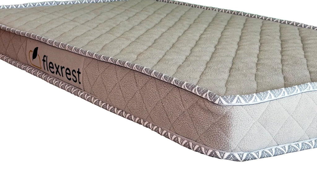 Close-up of the Flexrest label on the side of the Nurture mattress with quilted fabric and woven piping