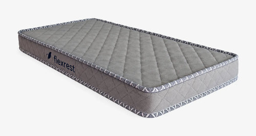 Flexrest Nurture Mini baby mattress, grey quilted cover with white woven piping, seen from a three-quarter angle